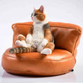 Lazy cat ornament with sofa on car dashboard, 7.5cm high resin model with fabric art details