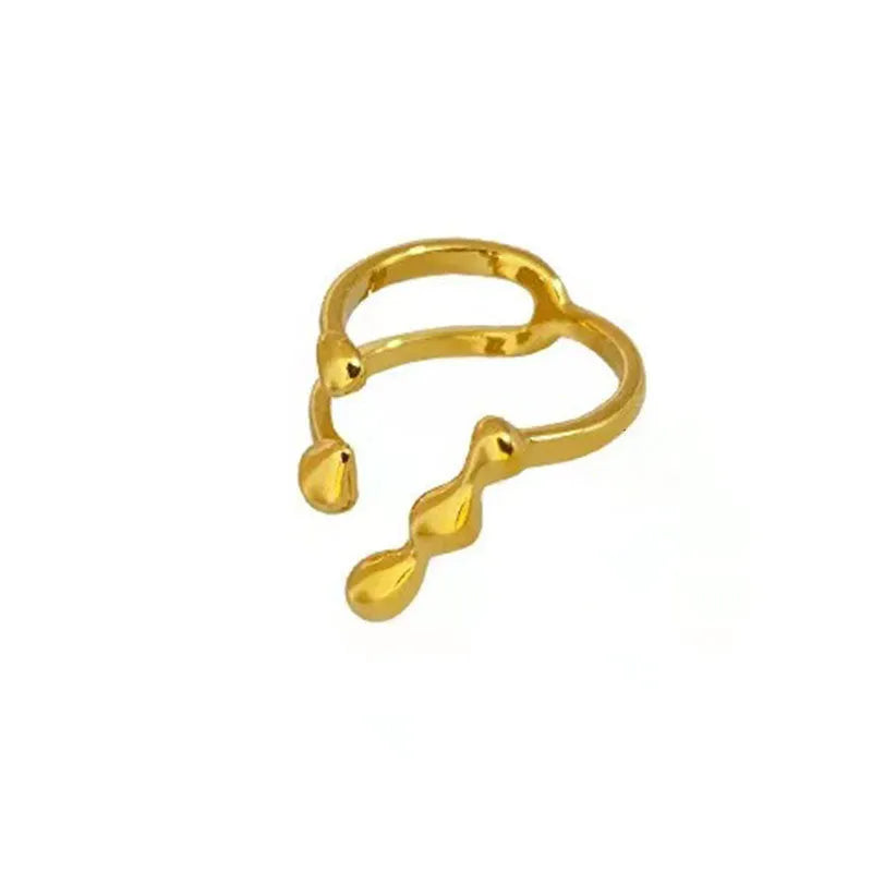Gold and silver brass opening ring with sphere circle design on a woman's hand.