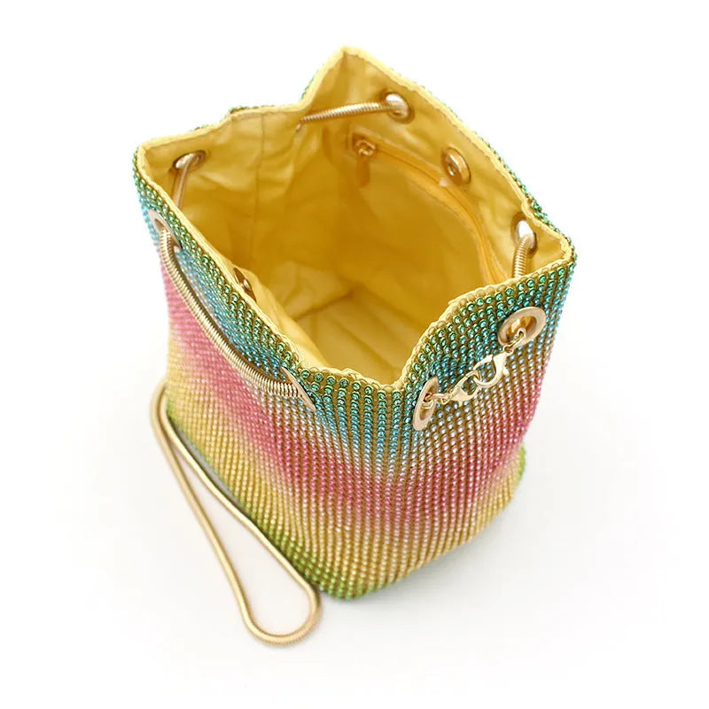 Colourful rhinestone bucket bag with glitter finish and soft fabric construction