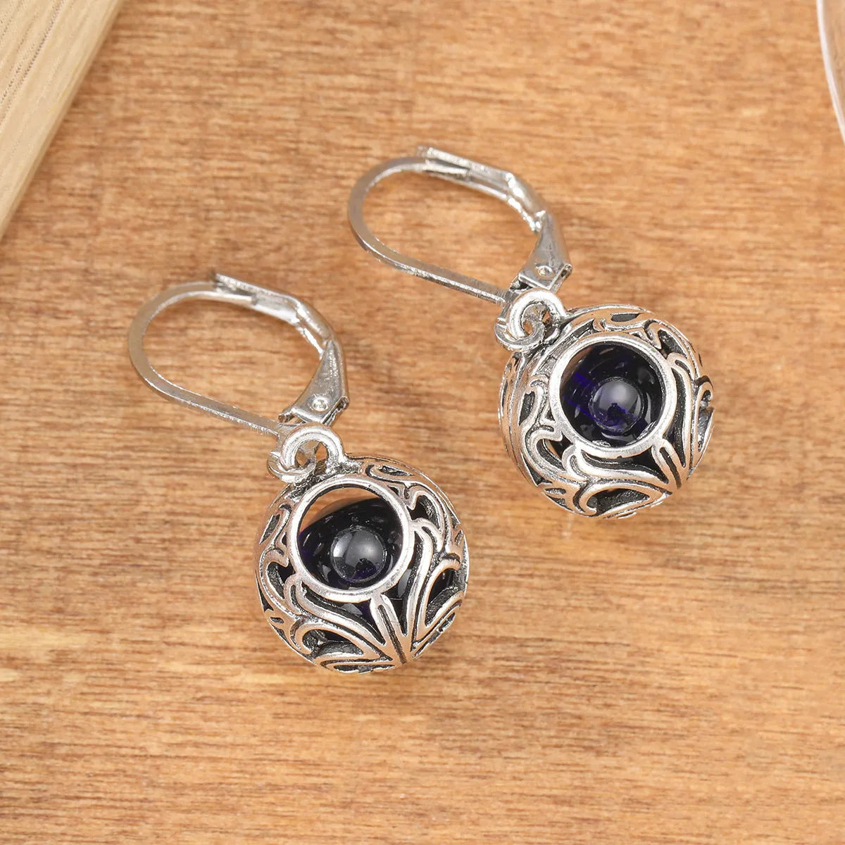 Women's silver geometric hollow pendant earrings with vintage engraving and blue gemstone accents