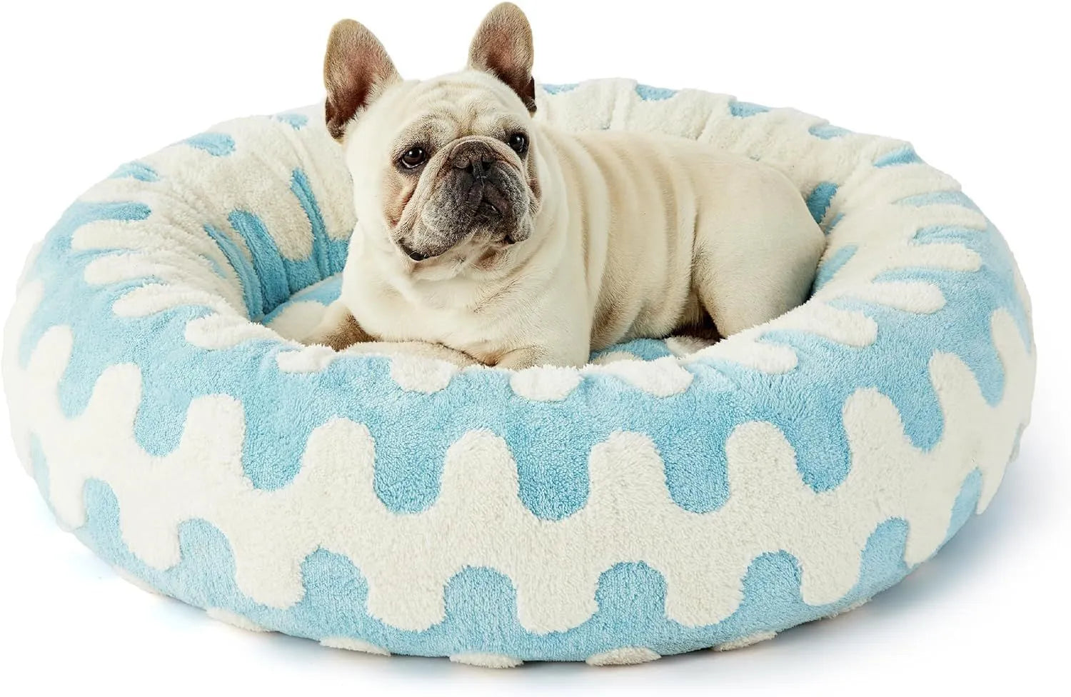 Round plaid dog bed with plastic base on a wooden floor