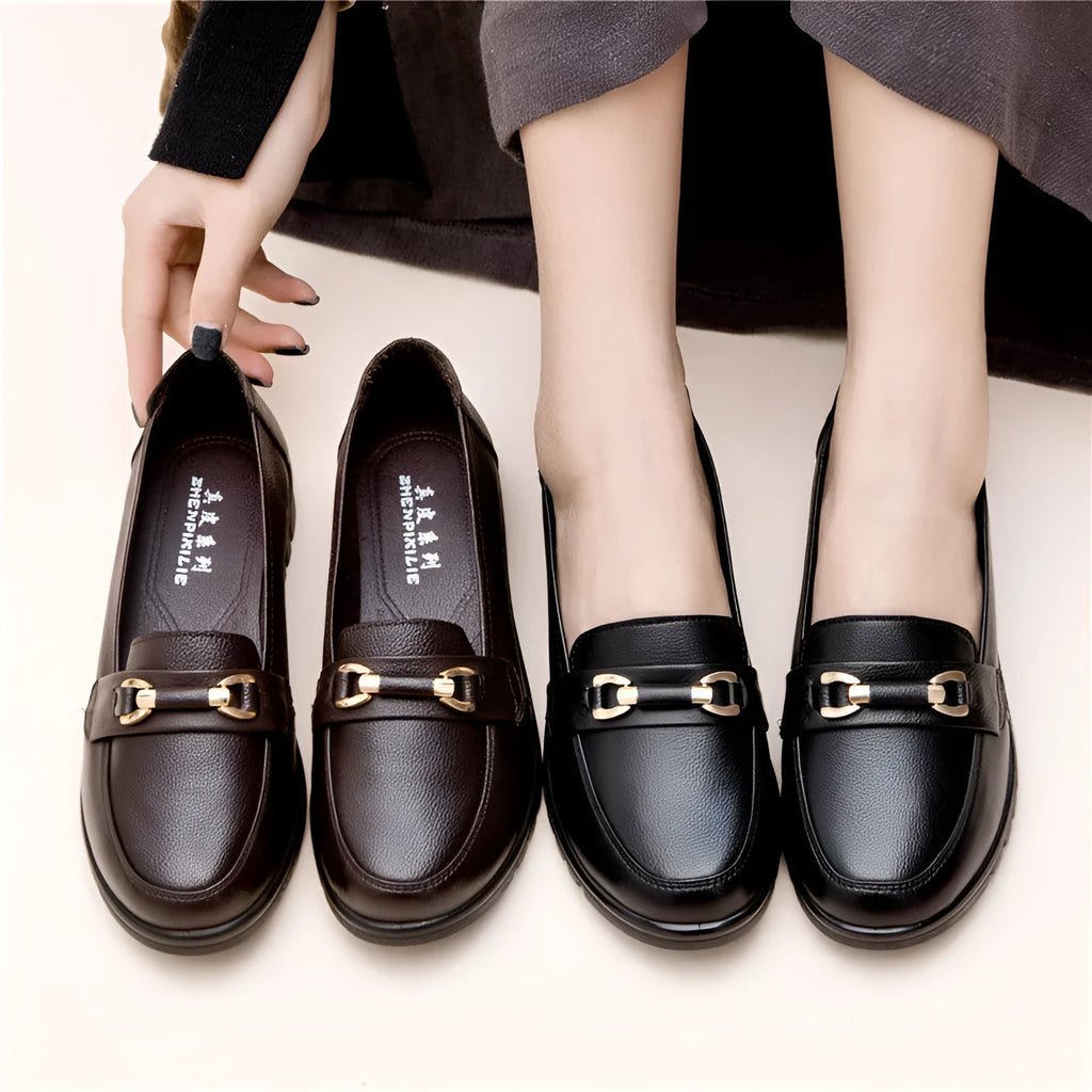 Black women's microfibre slip-on pumps with a round toe and low flat heel on a rubber sole.