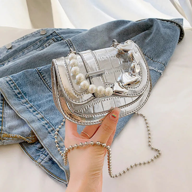 Silver laser pearl tote saddle mini crossbody bag for women on a model