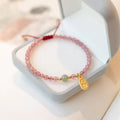Hand-woven red rope bracelet with strawberry quartz crystals and garnet beads