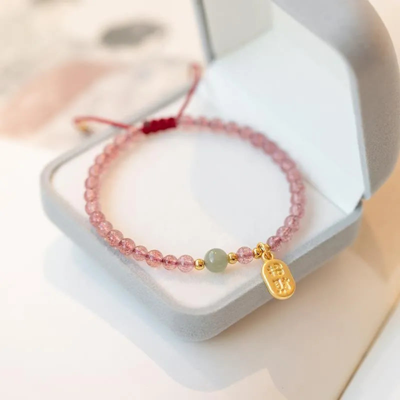 Hand-woven red rope bracelet with strawberry quartz crystals and garnet beads