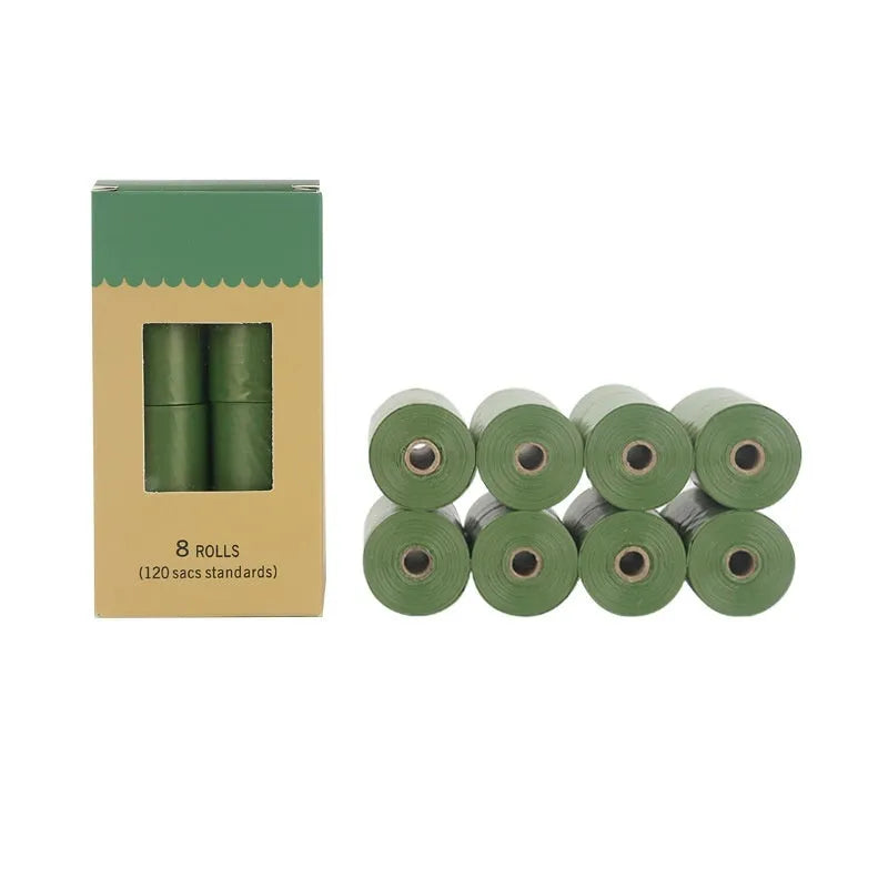 Rolls of green EPI degradable pet waste bags next to a transparent dispenser unit.