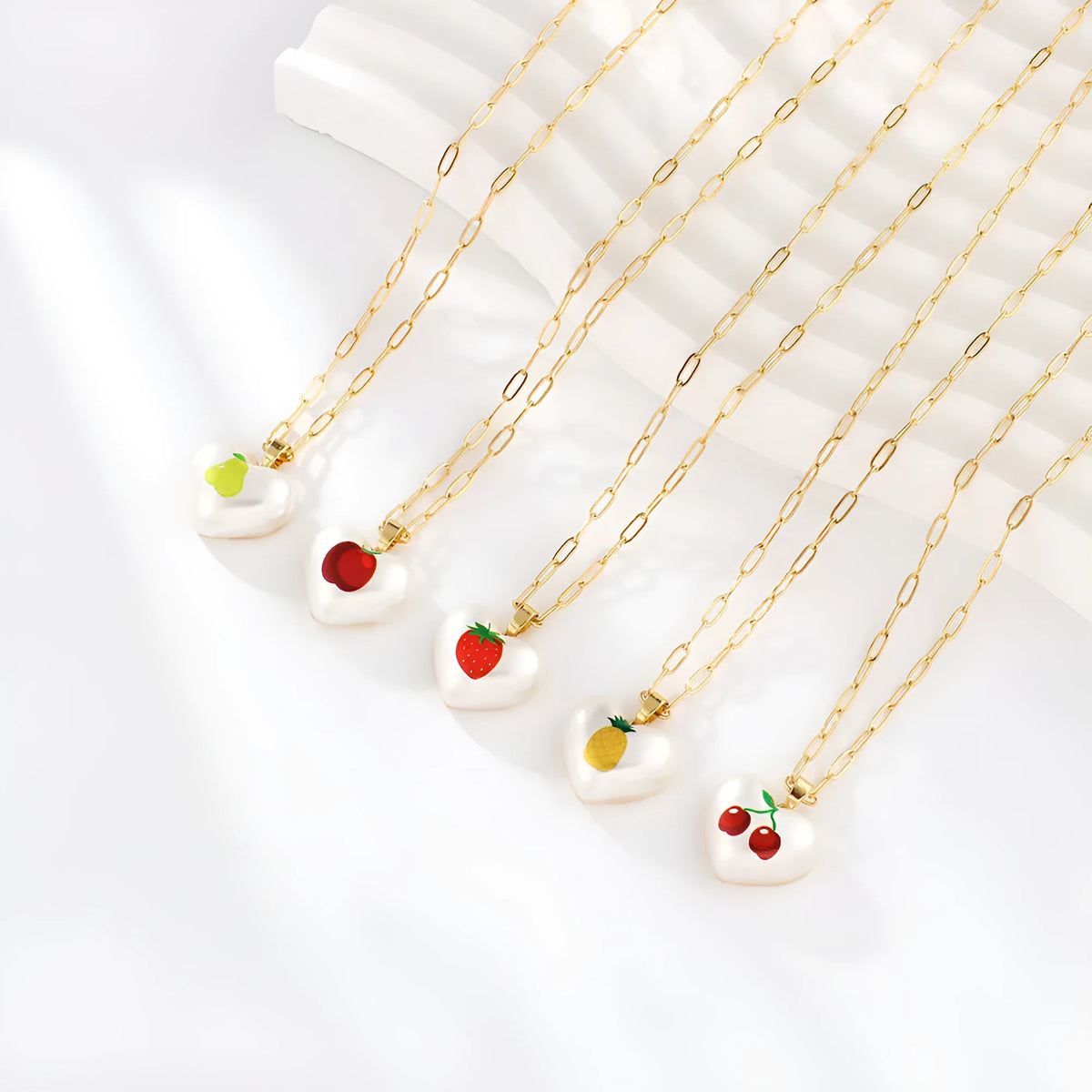 Geometric fruit pendant necklace on adjustable 21-50cm chain with strawberry, pineapple, apple, cherry, and pear colour options