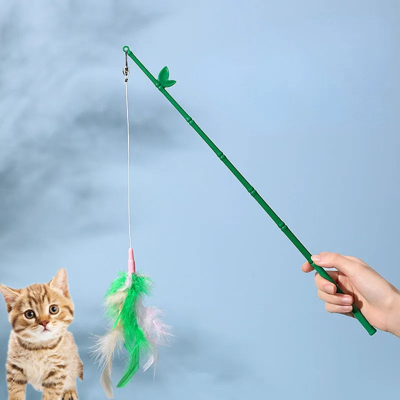 Green interactive cat feather wand toy with bells attached for indoor play and training