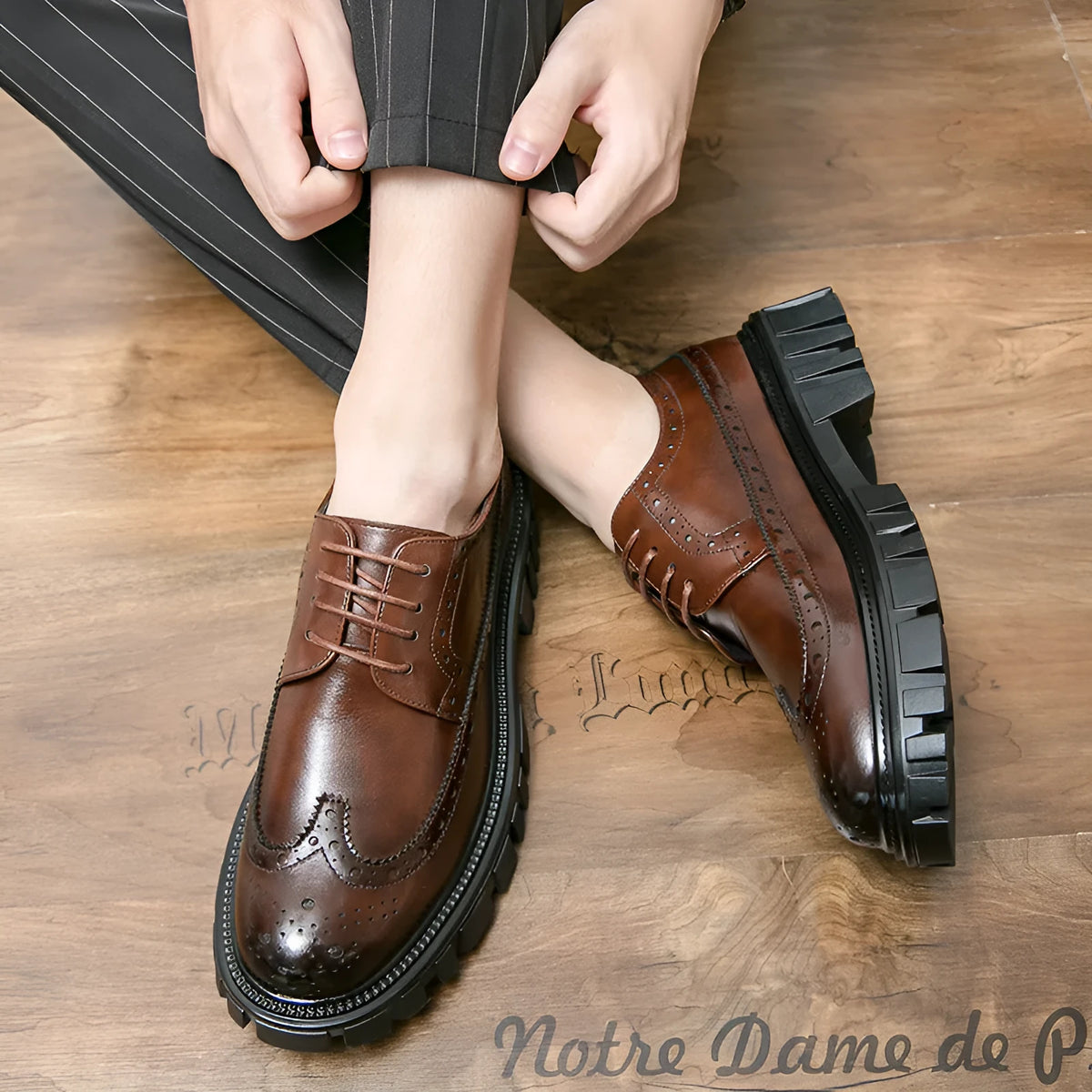 Men's black brogue leather shoes with round toe on a solid background