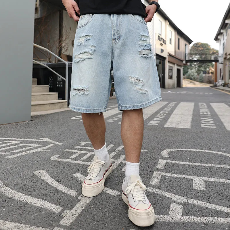Light blue ripped denim shorts with distressed detailing and loose straight-leg silhouette