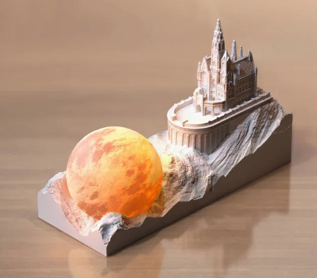 Mountain-shaped night light with LED touch control, essential oil bottle, and gift card on a wooden desk