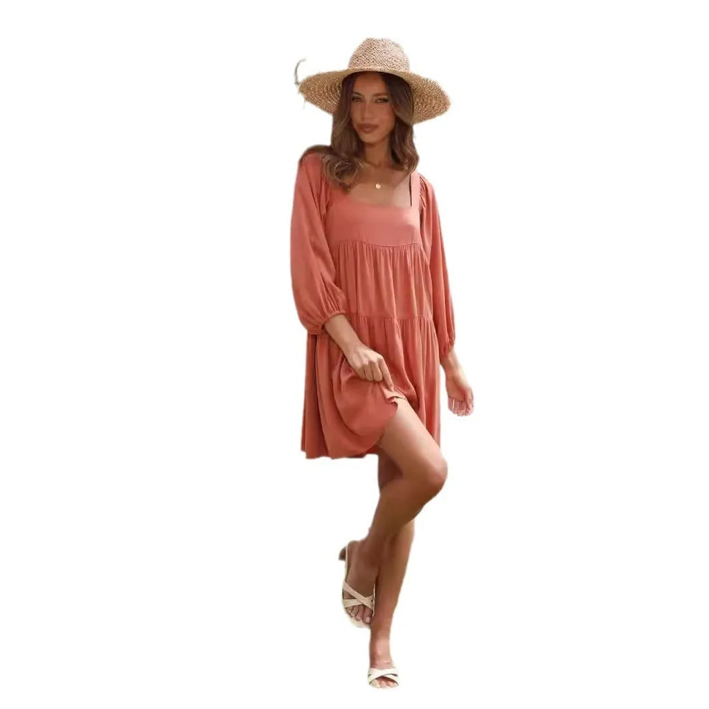 Orange backless children's dress with puff sleeves, a square collar, and a loose A-line skirt.