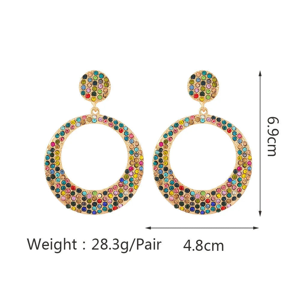 Large round metal pendant earrings with diamond accents in cartoon style for women