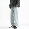 Men's light blue straight leg jeans with button waist closure on hanger