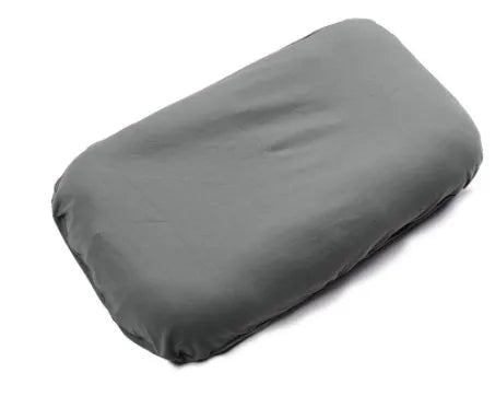 Beige portable baby nest crib cot for newborns on a neutral background.
