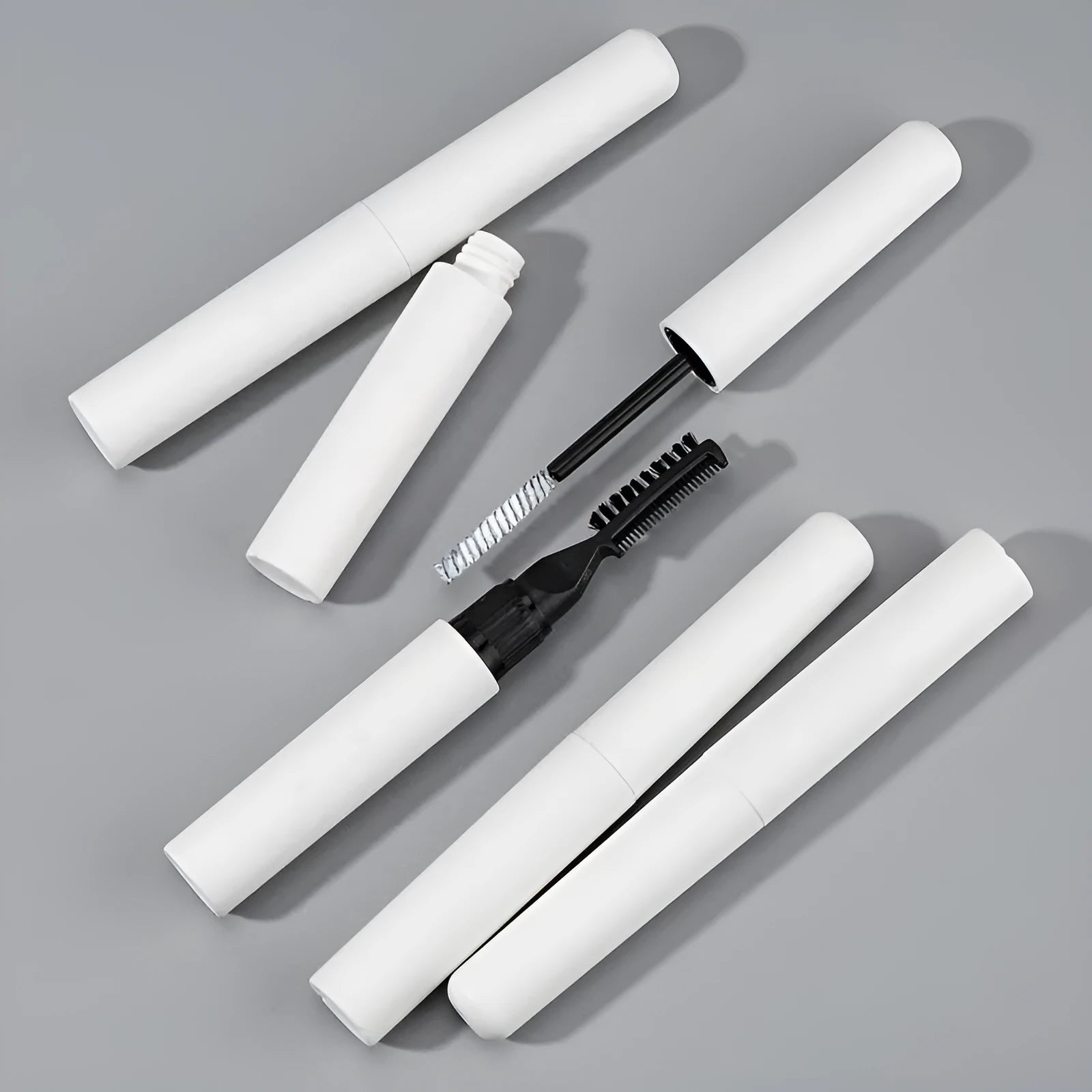 Pink and white eyebrow glue tube with applicator brush for natural wild brow styling.