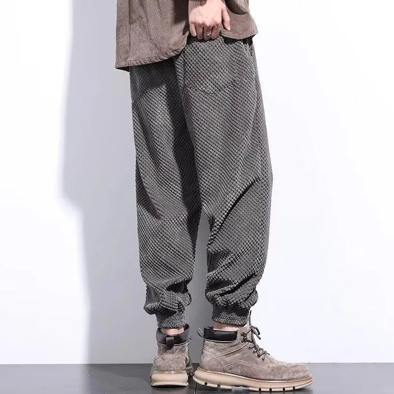 Men's grey casual sweatpants with ankle tie detail showing straight-leg silhouette