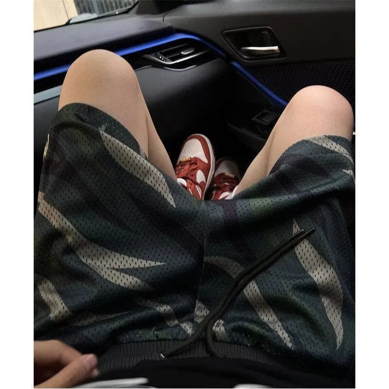 Men's straight-leg camouflage shorts in a cotton blend fabric, laid flat.