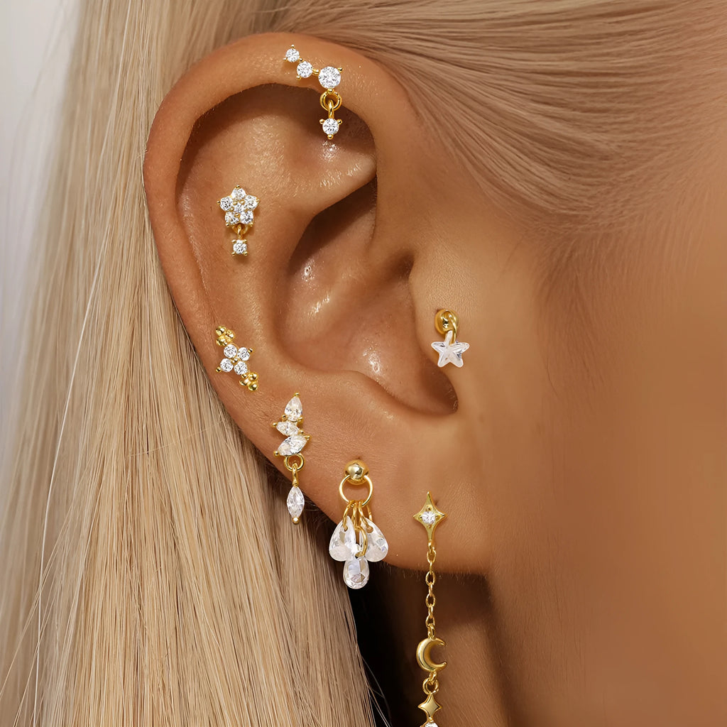 S925 sterling silver moon and star earrings with embedded diamonds on a gold tone background.