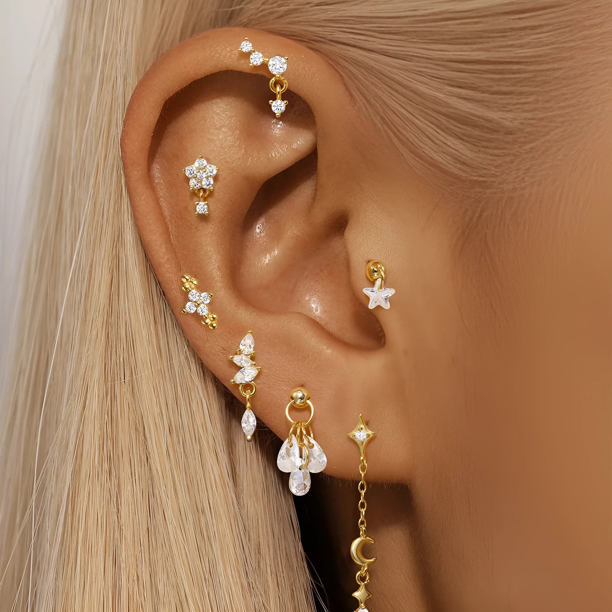 S925 sterling silver moon and star earrings with embedded diamonds on a gold tone background.