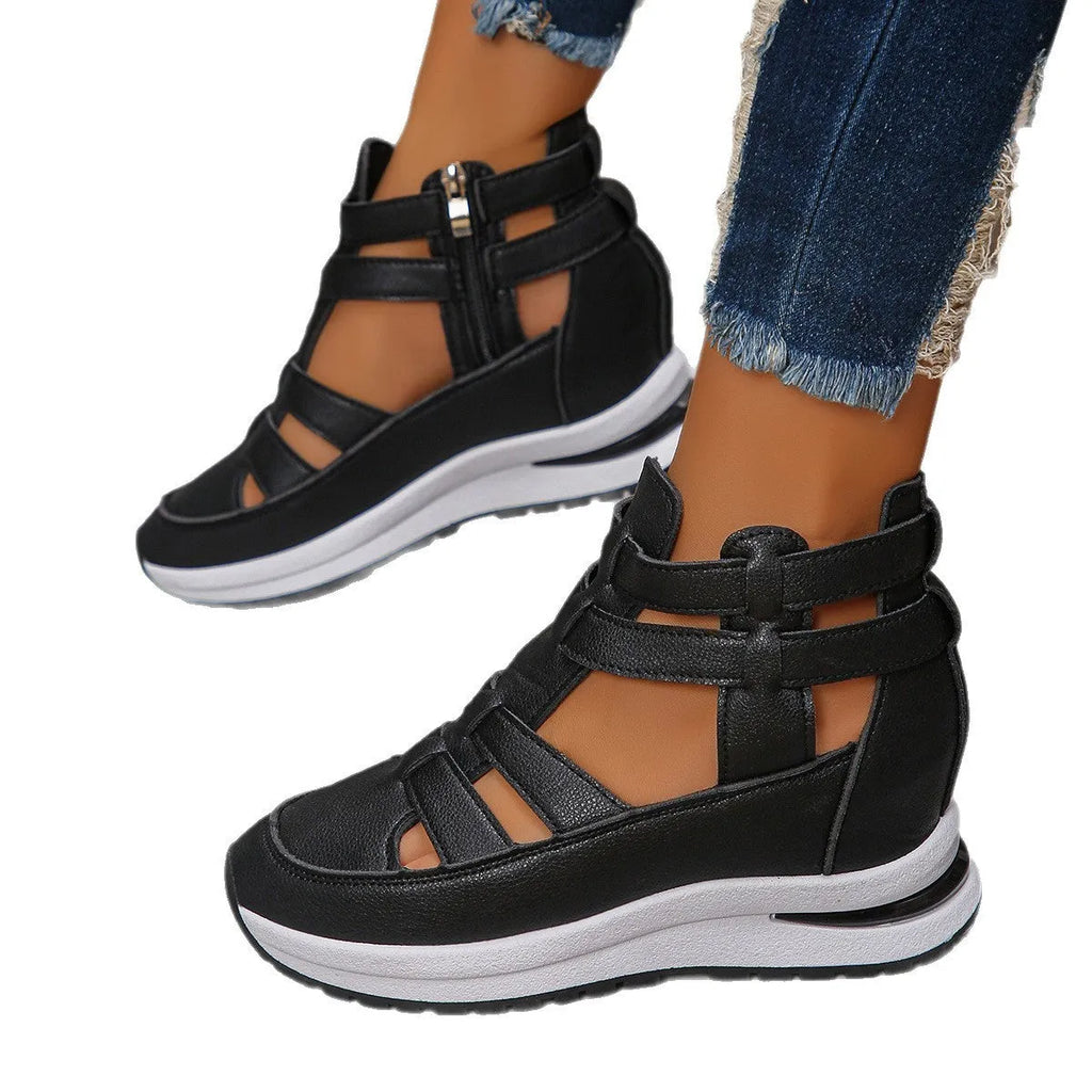 Black women's platform sandals with close toe, hollow-out sides, and a Velcro strap.
