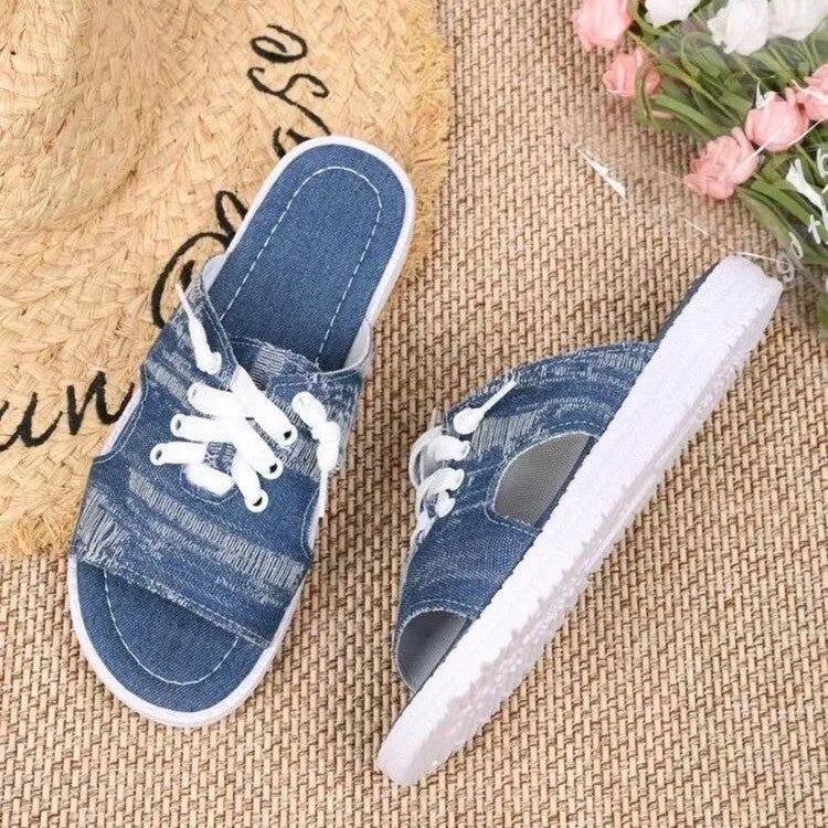 Blue Roman style women's canvas slippers with cloth upper and rubber sole.