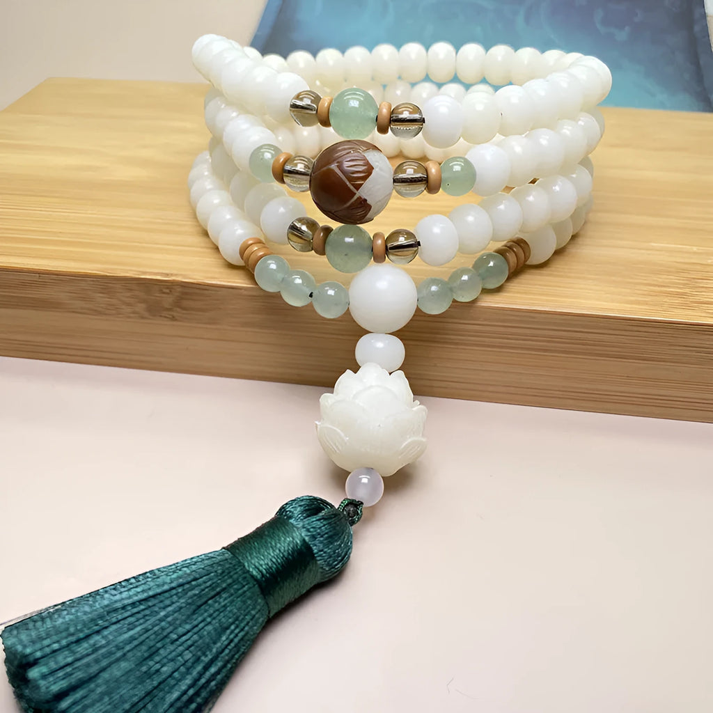 White Jade Bodhi beaded bracelet with 108 beads in a unisex design on a wrist.