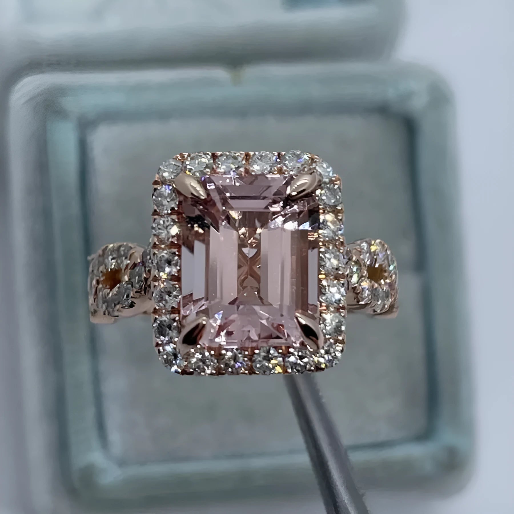 Rose gold geometric alloy ring on a plain background, showing its electroplated finish.