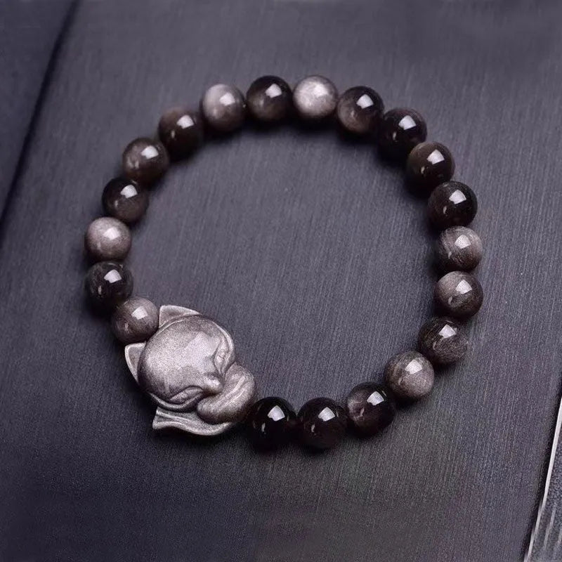 Obsidian fox charm bracelet for women showing a single black polished 8mm stone carved into a fox design.