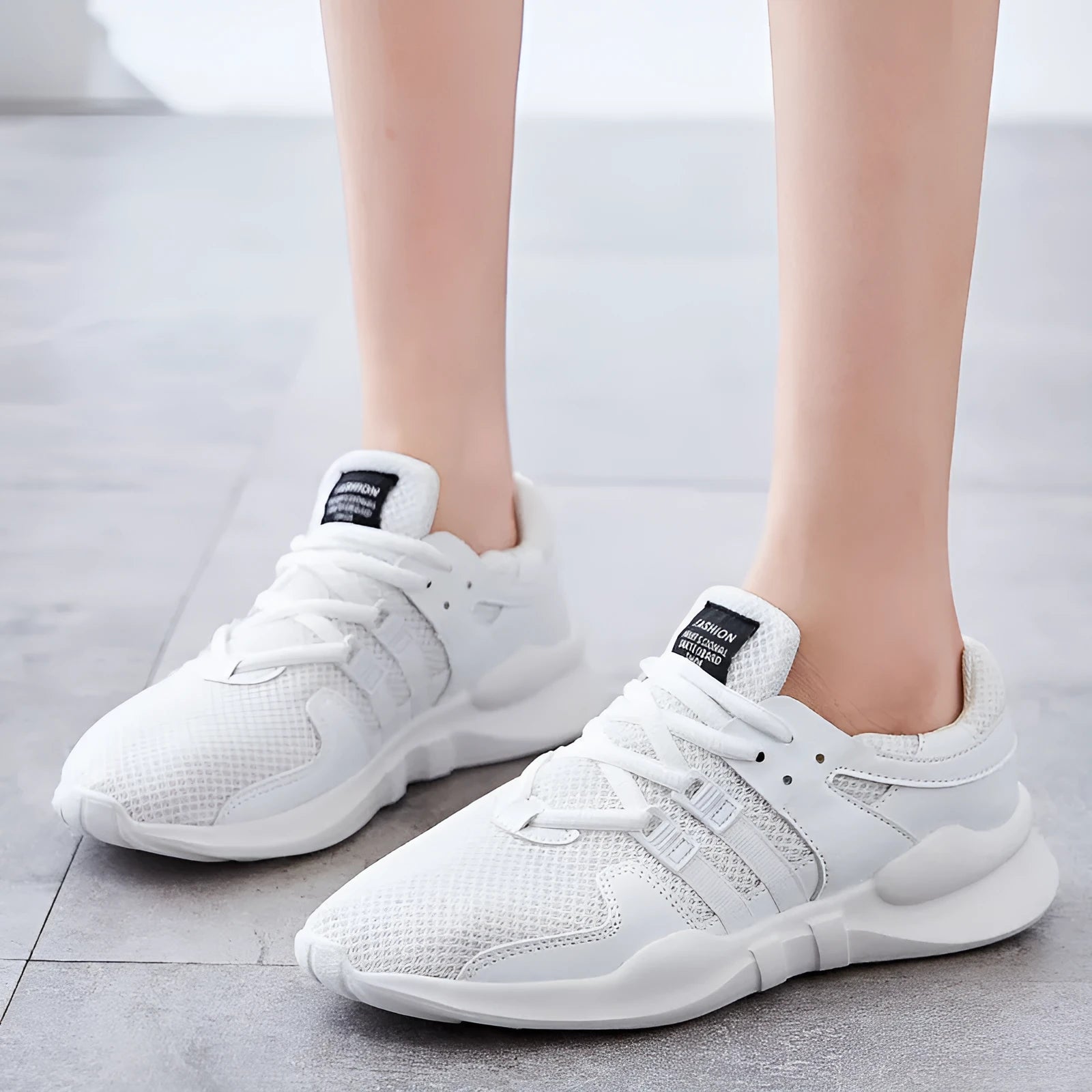 Casual mesh sneakers with hollow-out breathable design and round toe in black and white colour options