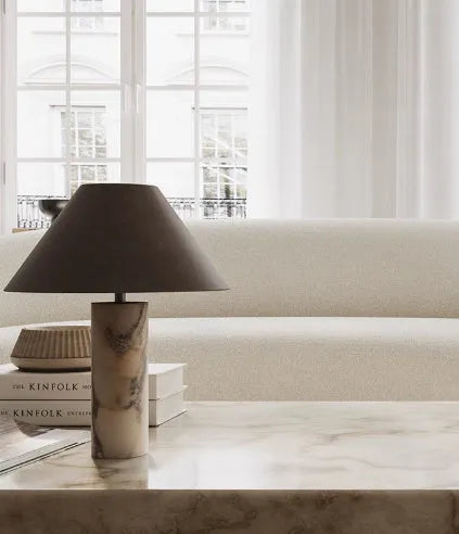 Modern black shade table lamp with marble base on wooden surface