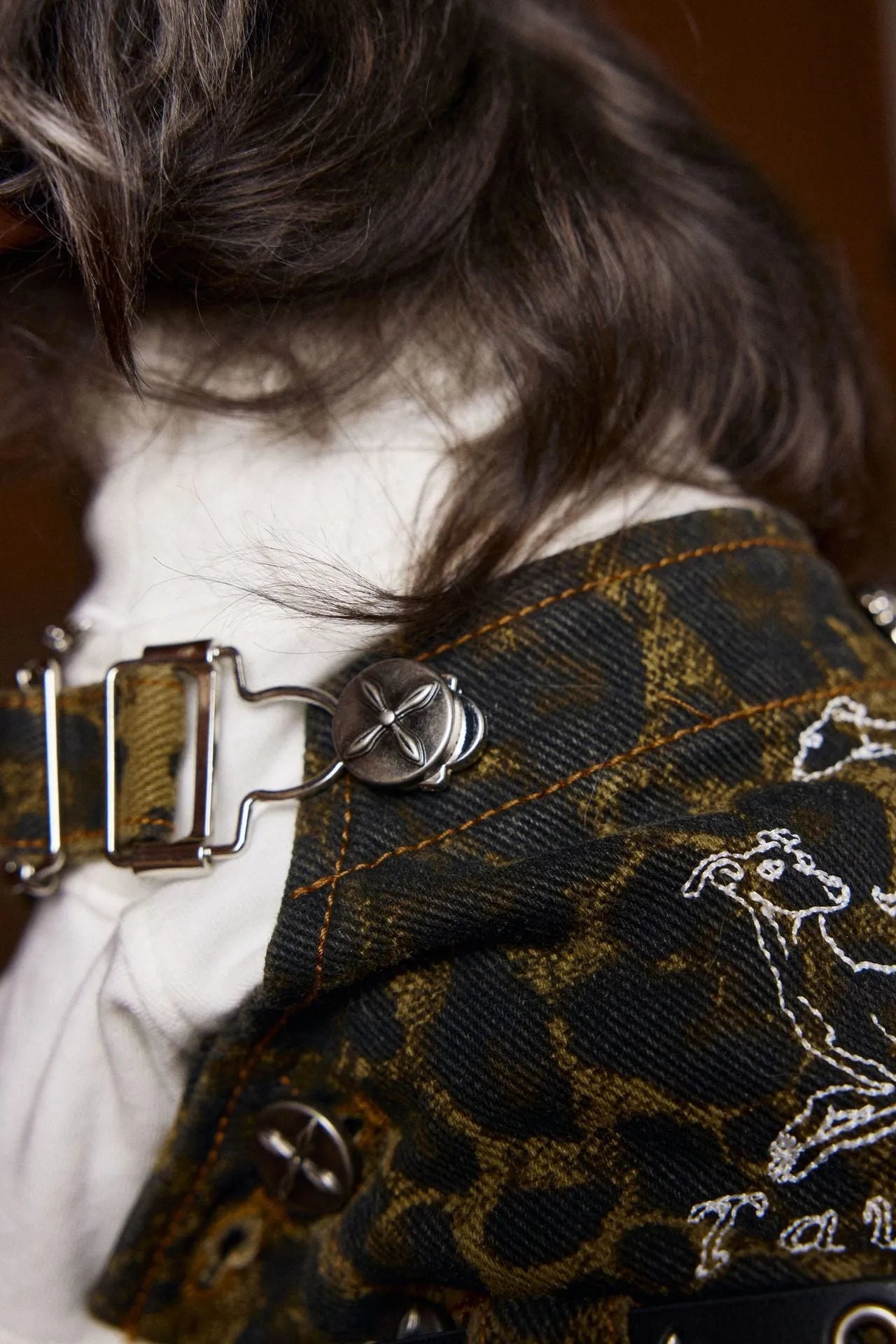 Dog wearing leopard print cotton overalls in a casual autumn outdoor setting