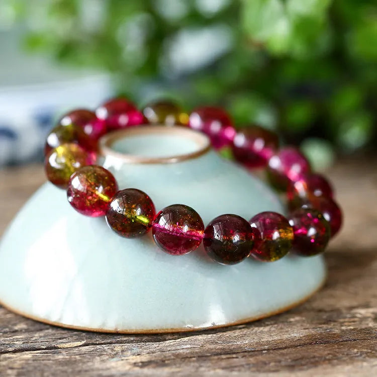 Watermelon crystal bead bracelet for women on a wrist, showing casual pastoral style.