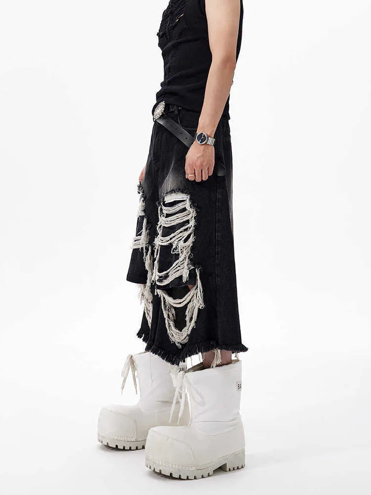 Black women's cropped wide-leg jeans with a ripped patch detail on the leg.