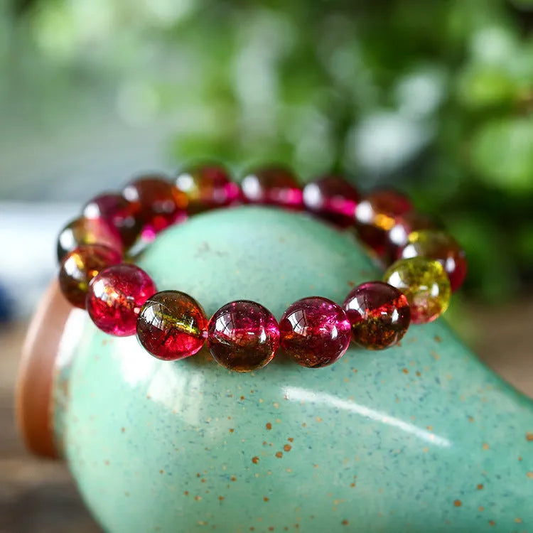 Watermelon crystal bead bracelet for women on a wrist, showing casual pastoral style.