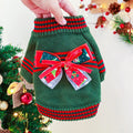 Red and green Merry Christmas design dog jumper on a small pet, showing the festive pattern and knit construction.