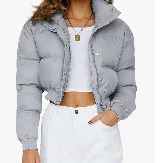 Women's loose blue polyester jacket with long sleeves on a hanger