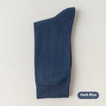 Men's solid colour mid-calf socks in combed cotton, shown in a range of neutral shades including beige, black, and dark blue.