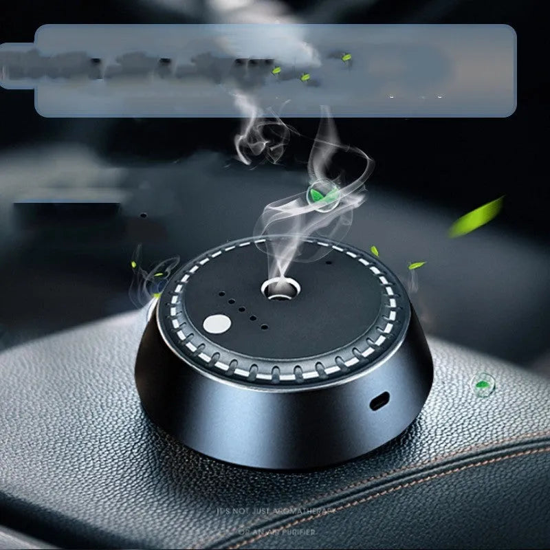 Black metal USB rechargeable car aroma diffuser with 30ml tank on a car dashboard.