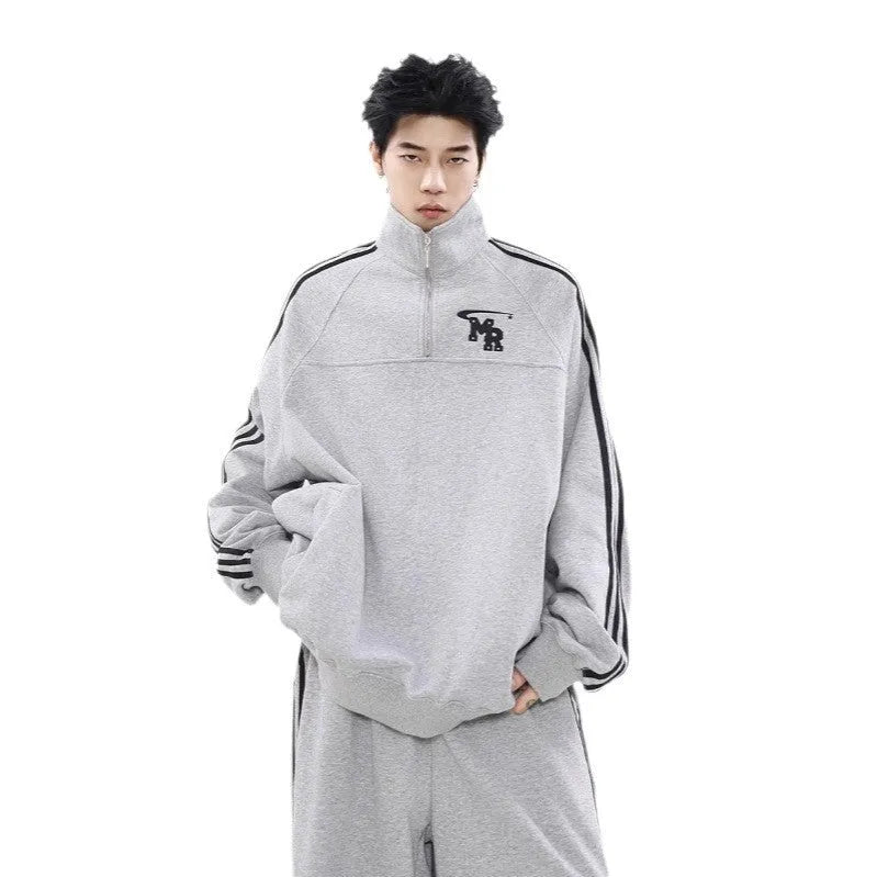 Black Hong Kong style polyester sports hoodie with stand collar and long sleeves on a hanger.