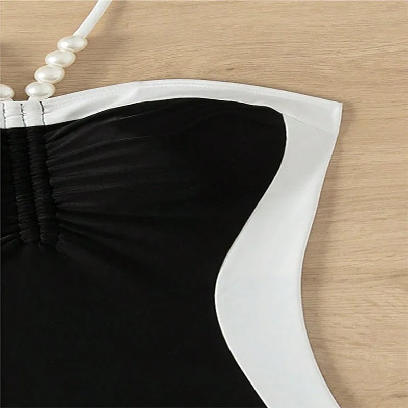 Black and white women's slim fit one-piece swimsuit with pearl spaghetti straps.