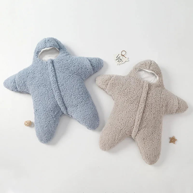 Baby lamb velvet starfish sleeping bag in khaki, hooded with zip and cuffs, lying flat on a surface
