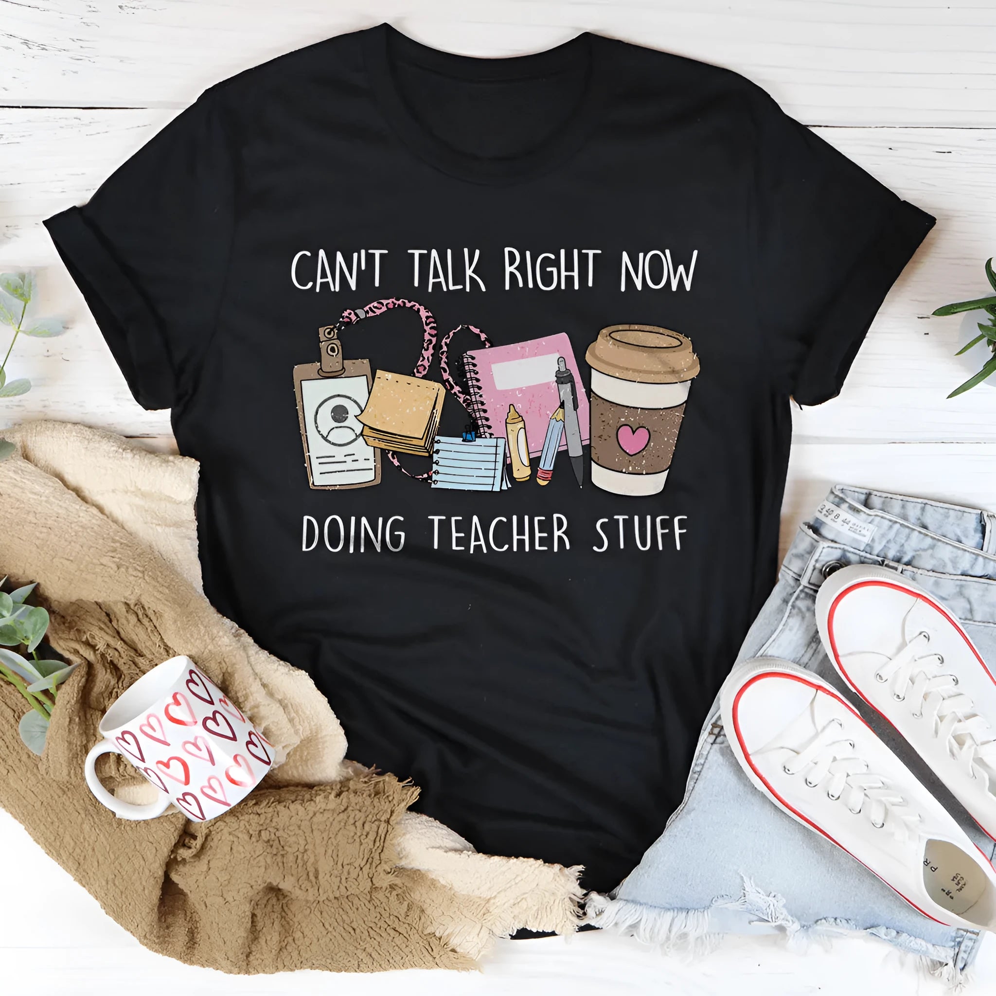 Black loose fit cotton t-shirt with short sleeves and a round neck on a hanger