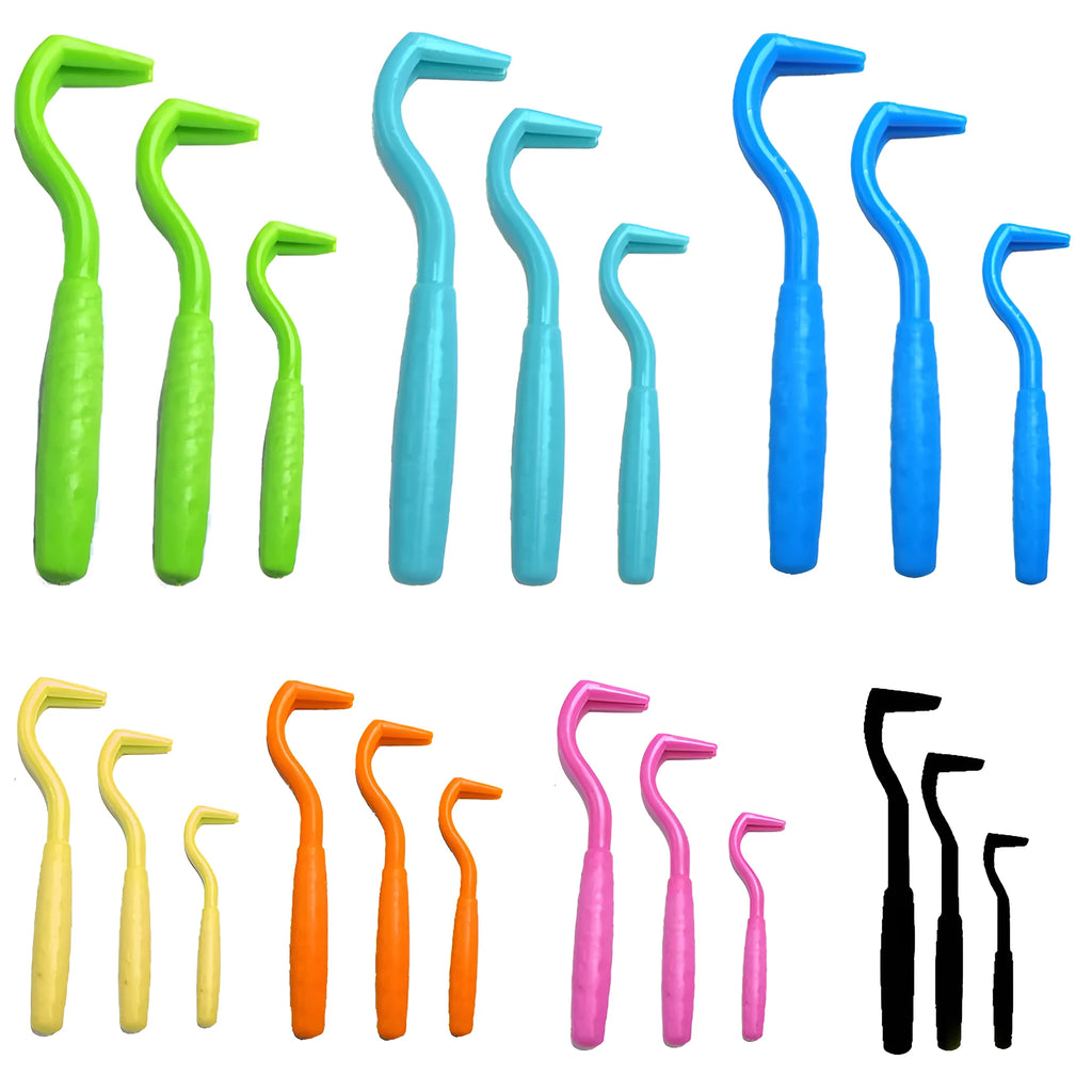 Set of three coloured tick removal hooks for dogs on a plain background.