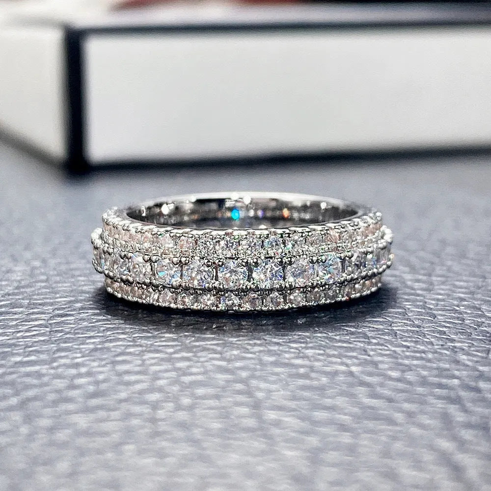 Geometric triangular ring with a zircon stone inlay, shown in white gold, yellow gold, and white and black finishes.
