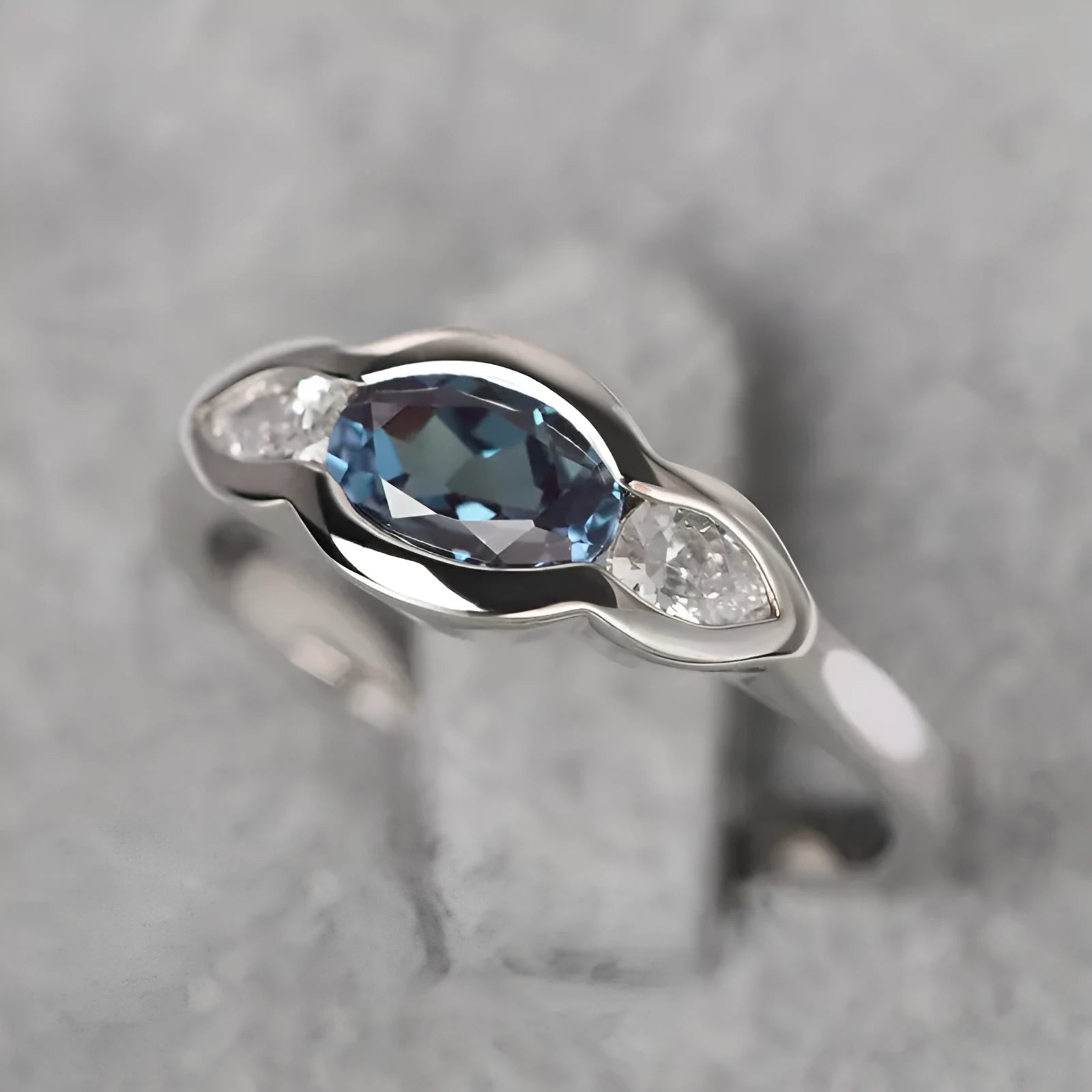 Geometric ellipse zircon ring in white gold finish on a copper band.