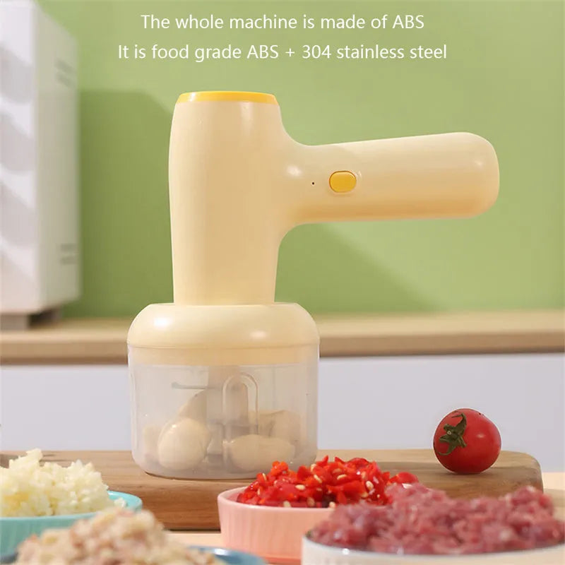 Beige yellow USB rechargeable electric garlic chopper with 250ml cup and 304 blade on a kitchen counter