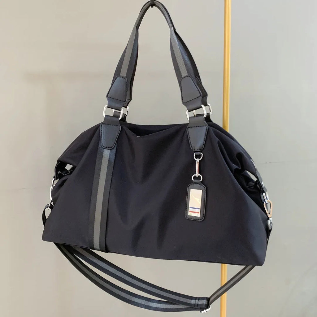 Men's black gold Oxford cloth travel bag with zipper opening and three shoulder straps shown on a neutral background