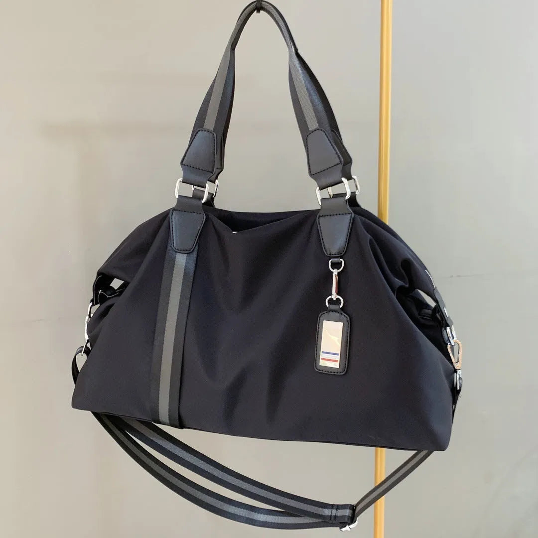 Men's black gold Oxford cloth travel bag with zipper opening and three shoulder straps shown on a neutral background
