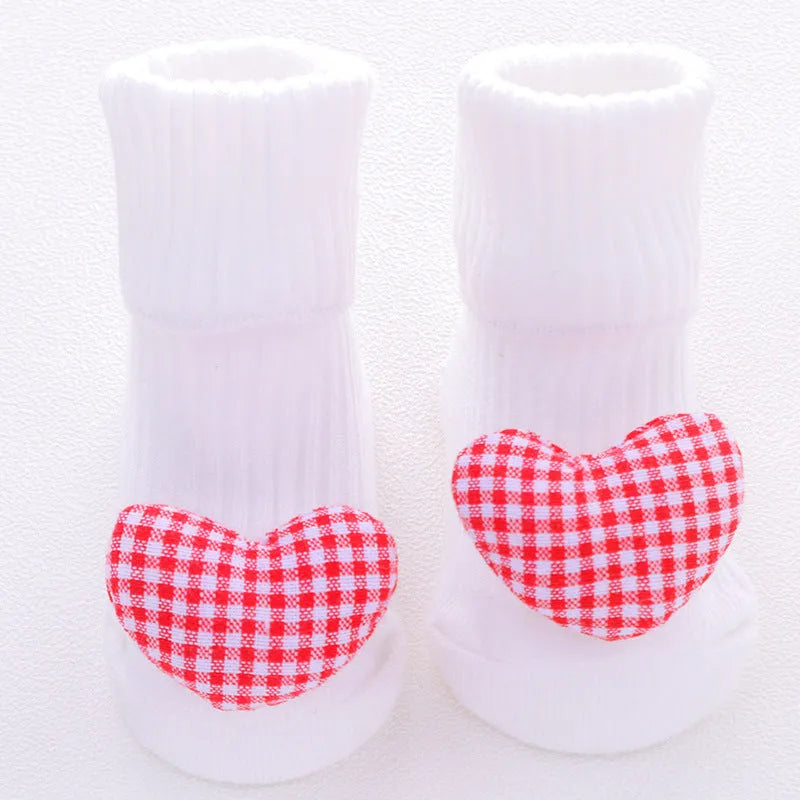 Cotton baby floor socks in assorted colours and patterns including bows, stars, and animal designs.
